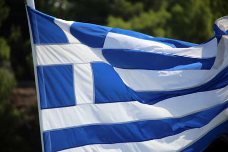 Greek flags waving outdoor on strings during summer weather.の写真素材