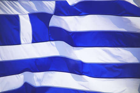 Greek flags waving outdoor on strings during summer weather.の写真素材