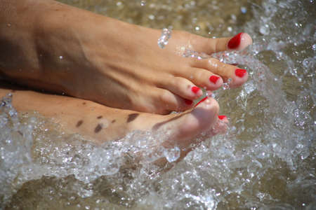 Relaxation in water. Female foot in healing water.
