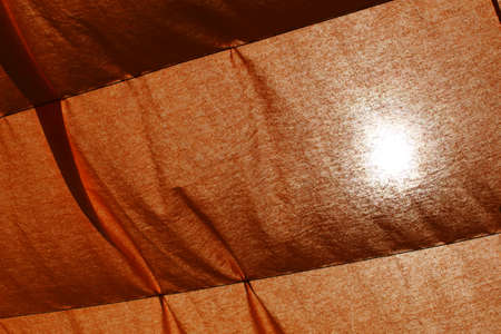 Texture of a open beach umbrella with translucent rays of blue and yellow. Background for holiday, vacation and summer concept.の写真素材