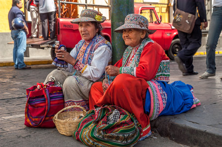 Woman Sitting on The Sidewalk in Arequipaのeditorial素材