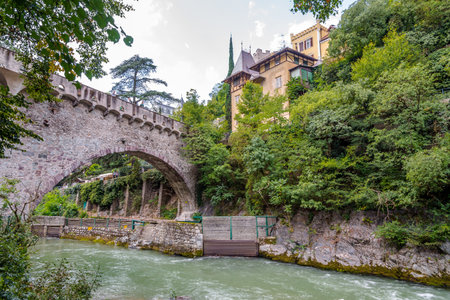 MERANO,ITALY - SEPTEMBER 2,2015 - Stone bridge over Passer river in Merano. Merano is a town and commune in South Tyrol, northern Italy.のeditorial素材