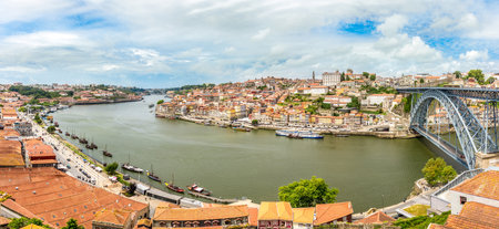PORTO,PORTUGAL - MAY 13,2017 - Panoramic view at the embankment Ribeira of Douro River with bridge of Luis I. in Porto. Porto is located along the Douro river estuary in Northern Portugal.のeditorial素材