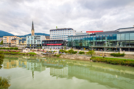 VILLACH, AUSTRIA - SEPTEMBER 15,2018 - View at the embankment of Drava river in Villach. Villach is...