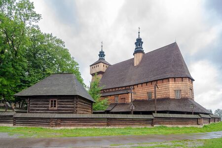 View at the Wooden Church of Assumption of Holy Mary and Saint Michael Archangel from 14th century in Haczow village, Polandの写真素材