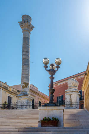 Steps with Ancient Roman Column in the streets of Brindisi in Italyの写真素材