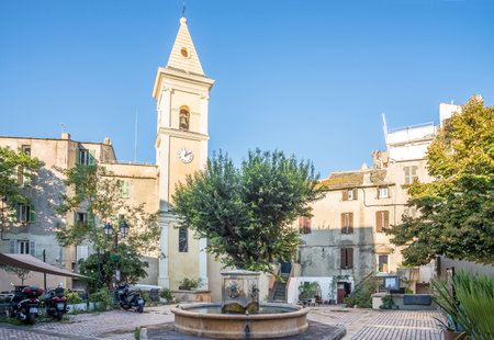 SAINT FLORENT,FRANCE - SEPTEMBER 7,2023 - Fountain and church of Santa Anna in the streets of Saint-Florent.Saint-Florent is a commune in Haute-Corse department on the island of Corsica, France.のeditorial素材