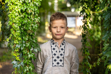 Serious Young Boy Standing Between Green Ivy Leaves Natural Portrait