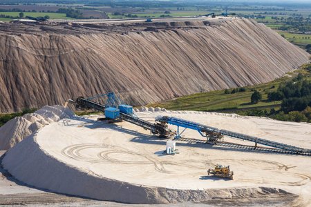 Industrial Salt Mining Site with Conveyor Systems, Large White Salt Mountain and Heavy Machinery