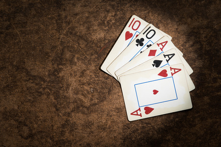old playing cards collected from a combination of poker full houseの写真素材