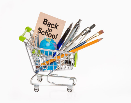 high resolution photo of trolley with school equipment on white background and a card with the words "back to school"の写真素材