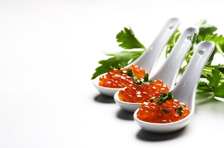 Red caviar in ceramic spoon
