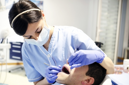 Woman dentist with patient doing oral examの写真素材