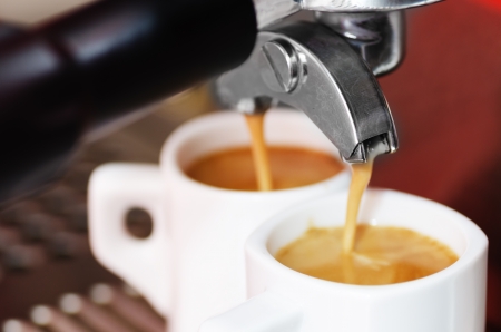 Close-up of an espresso machine making acup of coffeeの写真素材