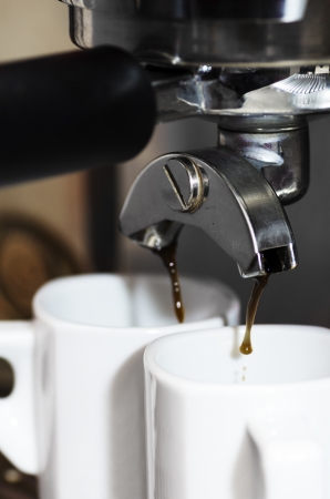 Close-up of an espresso machine making acup of coffeeの写真素材