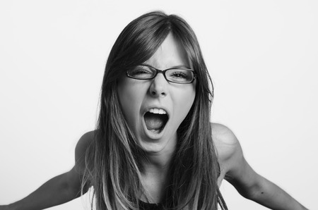 Angry woman screaming on white の写真素材