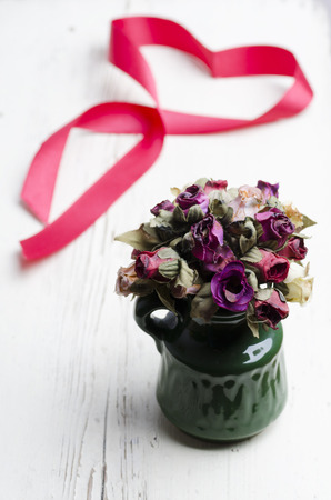 Vase with fake handmade flowers on wooden tableの写真素材