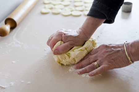 Kneading dough on wooden boardの写真素材