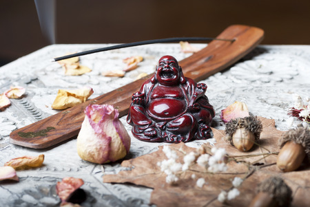 Buddah with scent stick on wooden tableの写真素材
