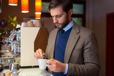 Business man in coffee shop, drinking espressoの写真素材