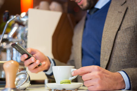 Business man in coffee shop, drinking espressoの写真素材