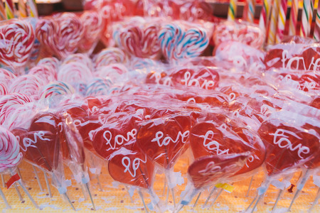 Heart shaped candies, lollypops and other treats and gifts, on the street, vintage style, retro filtered lookの写真素材