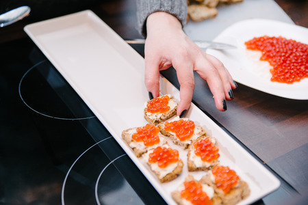Preparation of red caviar in domestic kitchen, shallow depth of field, focus on the caviarの写真素材
