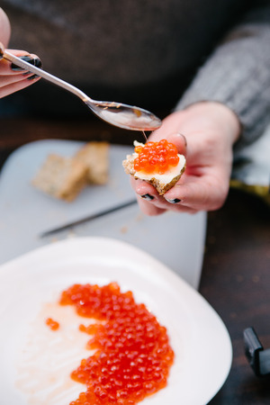 Preparation of red caviar in domestic kitchen, shallow depth of field, focus on the caviarの写真素材