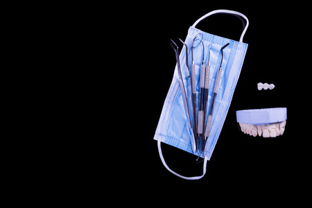 Dental instruments with mask on black
