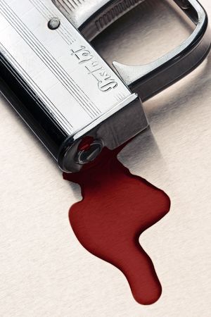 small pistol with the pool of blood under the nozzle - signの写真素材
