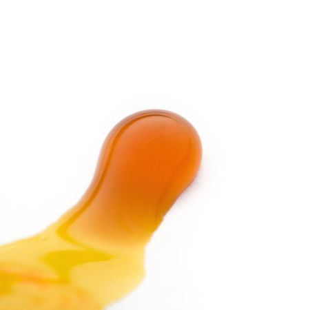 yellow ink drop on whiteの写真素材