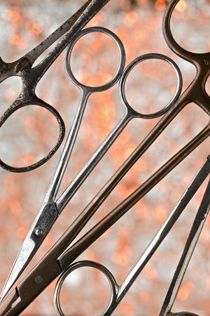 closeup of various scissors over burning-like background