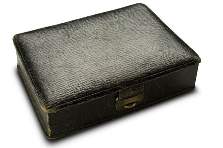 an old black leather box on whiteの写真素材