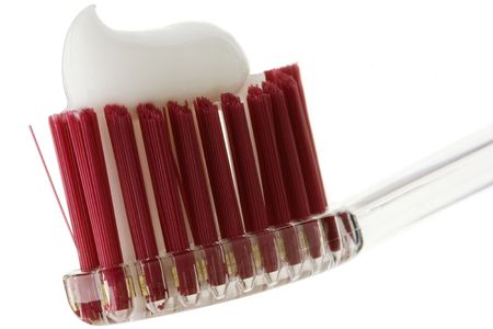 a toothpaste on a toothbrush against white backgroundの写真素材