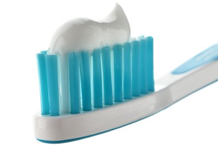 a toothpaste on a toothbrush against white background