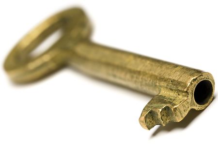 a golden key on white