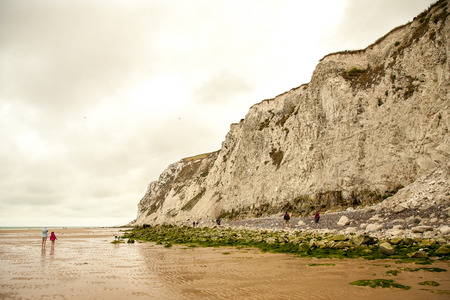 Beach with people, sea, sand, sky and boatの写真素材