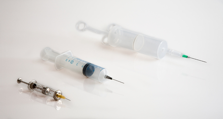 three syringes with needles and white backgroundの写真素材