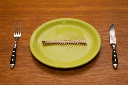 Plate with fish bone, fork and knife