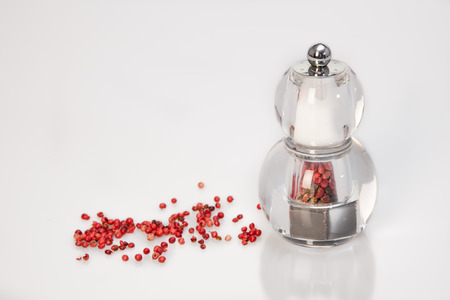 Transparent modern grinder with red pepper and saltの写真素材