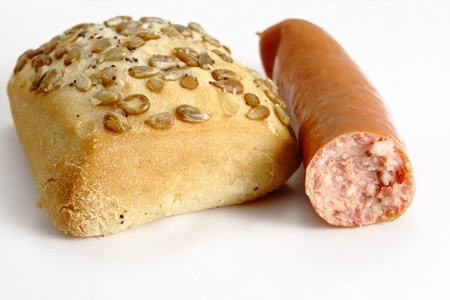 roll bread and sausage on the white backgroundの写真素材