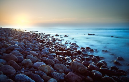 Stony calm Baltic beach seascape after sunsetの写真素材
