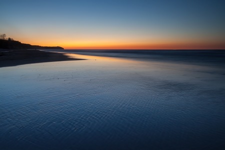 tranquil colorful landscape of sea coast (Baltic sea) photographet at sunsetの写真素材