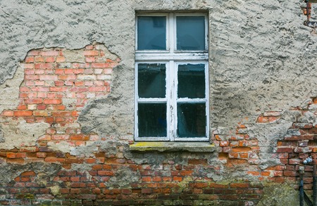 Old house wall with wooden - white painted window. usefull as backgroundの写真素材