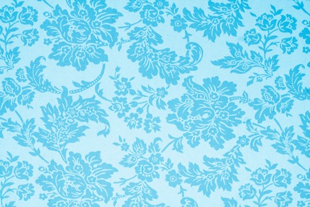Old color paper texture with vintage flowers ornament, useful as background in poster