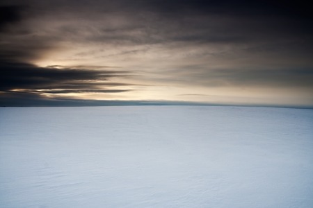 Winter field landscape with field covered by snow in Polandの写真素材