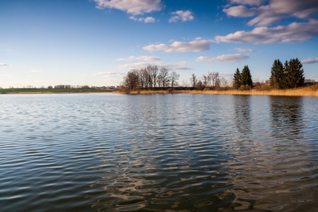 Beautiful polish lake landscape, tranquil rural countryside at springtimeの写真素材