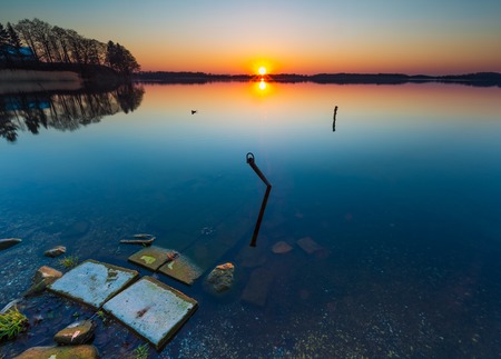 Beautiful lake at sunset. Boats mooring place.Tranquil scene photographed in Poland.の写真素材