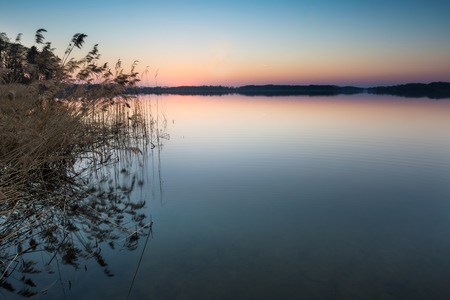 Beautiful lake landscape at sunset. Beautiful polish lake photographed in Mazury lake district.の写真素材