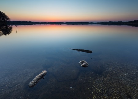 Beautiful lake landscape at sunset. Beautiful polish lake photographed in Mazury lake district.の写真素材